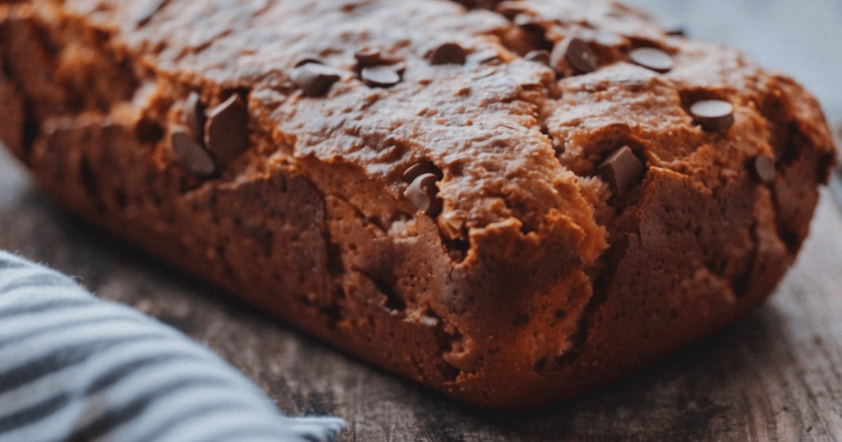 A freshly baked slice of banana bread recipe no butter, served on a plate with a soft, moist texture.