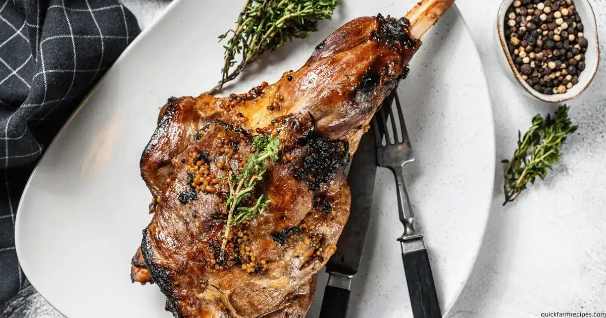 A roasted leg of lamb with crispy skin and mustard seeds, garnished with fresh thyme, served on a white plate.