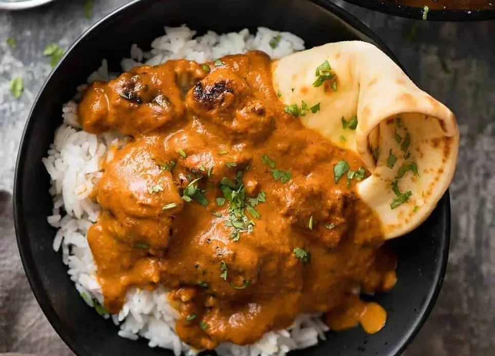Delicious Chicken Tikka Masala served with rice and naan bread